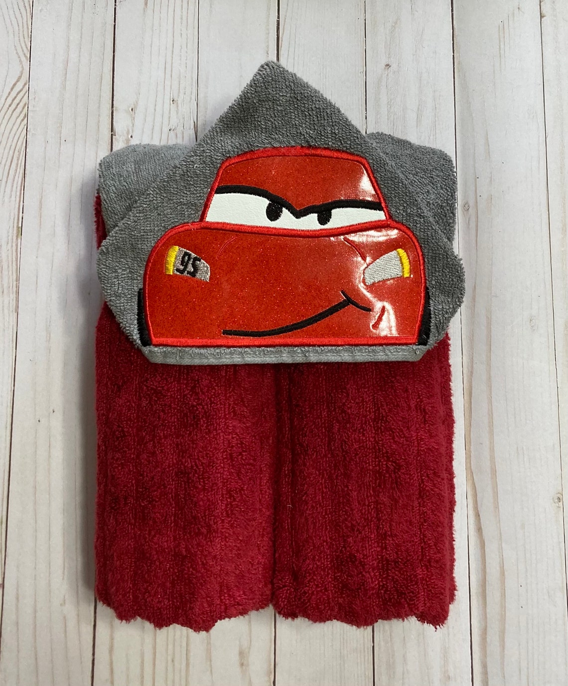 Hooded Towel with an embroidered race car on it. Etsy