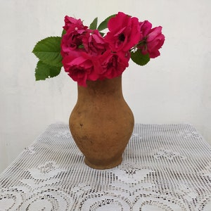 Old antique ancient clay vessel vase without handle. Brown clay pot. Rustic bowl. Primitive decor. Country decor