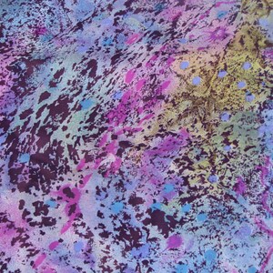 May include: Abstract fabric with a colorful, splatter-painted design. The fabric features shades of purple, pink, blue, and yellow.