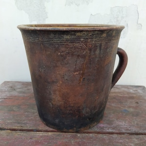 Old antique ancient clay vessel vase with handle. Brown clay pot. Rustic bowl. Primitive decor. Country decor