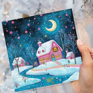 Carte de Noël Village enneigé rose et bleu avec rivière glacée, croissant de lune, scène magique de ciel étoilé d'hiver pour la famille et les amis Nouveau 2025
