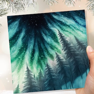 Carte d'aurores boréales hiver bois scène de neige paysage enneigé vert bleu aurore boréale flammes cartes pour famille amis Noël merci 23