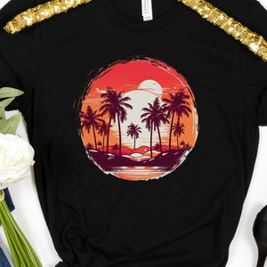 May include: Black t-shirt with a graphic of a sunset over palm trees in a circle. The graphic is in shades of red, orange, and yellow.