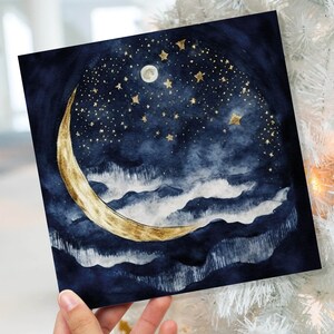 May include: A watercolour painting of a crescent moon with gold accents against a dark blue night sky with gold stars. The moon is set against a backdrop of white clouds.