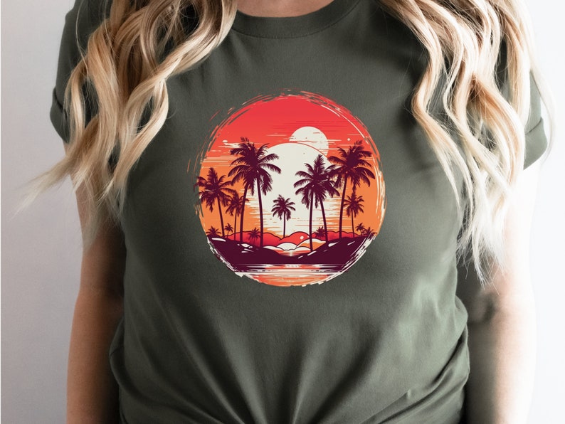 May include: A green t-shirt with a circular graphic of palm trees and a sunset. The graphic is in shades of red, orange, yellow, and brown.