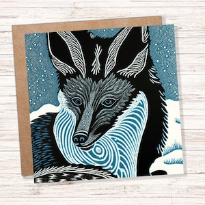 Linosnede kaart vos blauw winter besneeuwd illustratie wit zwart sneeuwscène vossen hoofd gezicht oren groeten voor familie vrienden Kerstmis bedankt