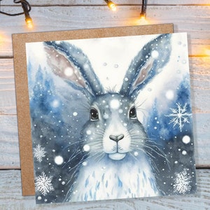 Betoverende winterhaaskaart prachtige blauwe besneeuwde aquarel sneeuwlichten sneeuwvlokken wenskaart voor familie vrienden Xmas 23 bedankt BFF