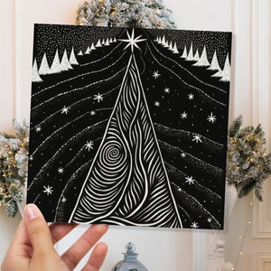 Carte de sapin de Noël noire linogravure monochrome étoiles magiques forêt étoilée scène de neige ciel nocturne enneigé salutations pour les amis de la famille Noël 2025