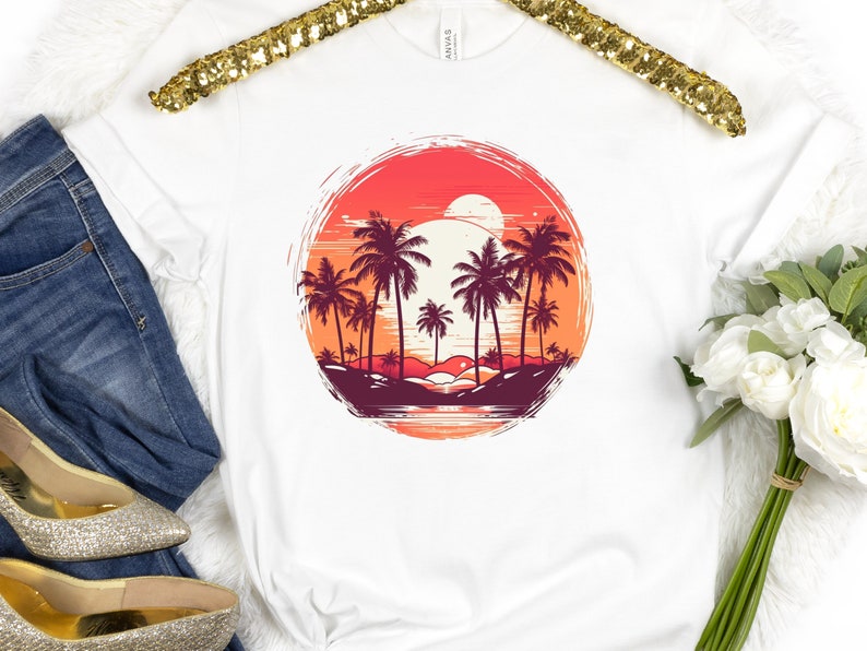 May include: White t-shirt with a graphic of palm trees and a sunset in a circle. The graphic is in shades of red, orange, and yellow.