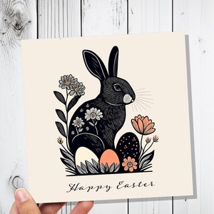 Jeu de cartes Joyeuses Pâques en linogravure avec lapin noir, art populaire élégant, lapin, fleurs et œufs, lièvre botanique respectueux de l'environnement