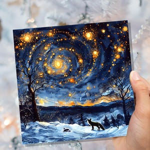 May include: A square art print depicting a winter scene under a swirling, starry night sky. The artwork shows a fox, trees, and snow. The colour palette includes blues, oranges, and gold, creating a magical, whimsical scene.