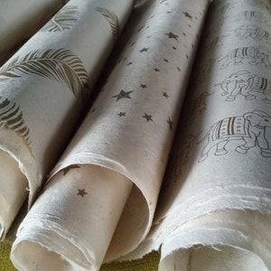 3 large deckle edge half/full sheets Nepali Lokta paper, natural cream color in feather, star and elephant gold block printed designs.