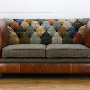 May include: A two-seater sofa with a patchwork design in shades of brown, green, blue, and red. The sofa has a tufted back and leather arms and base.