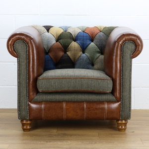 May include: A brown leather armchair with a patchwork design in various shades of blue, green, and brown. The armchair has a tufted back and a rolled armrest.