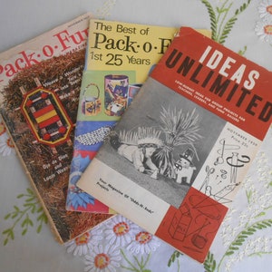 May include: Three vintage magazines with colorful covers. The top magazine is titled "Pack-o-Fun" and features a woven basket. The middle magazine is titled "The Best of Pack-o-Fun 1st 25 Years" and features a variety of crafts. The bottom magazine is titled "Ideas Unlimited" and features a group of children dressed in costumes.