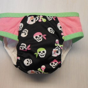 May include: Black and pink underwear with a green trim and a skull and crossbones print.