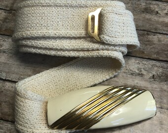 Vintage St. John ladies belt buckle with knitted belt.Cream enamel with gold strips