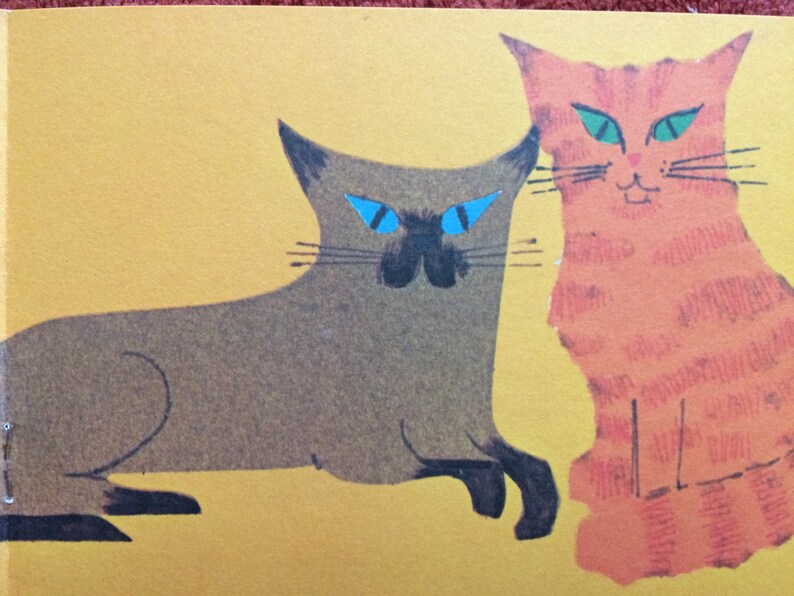 May include: Two cats, one brown and one orange, are depicted in a simple, stylized illustration. The brown cat has blue eyes and is lying down, while the orange cat has green eyes and is standing upright. The cats are on a yellow background.