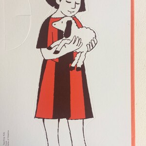 May include: A black and white illustration of a girl holding a white lamb. The girl is wearing a red and black dress.