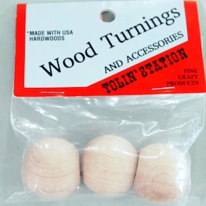 May include: Three unfinished wooden turnings in a clear plastic bag. The label reads "Wood Turnings AND ACCESSORIES TOLIN' STATION FINE CRAFT PRODUCTS" and "MADE WITH USA HARDWOODS". The turnings are light beige and egg-shaped.