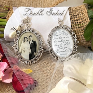 May include: Double-sided wedding charm with a silver frame. One side features a black and white photo of a couple in wedding attire. The other side has a message that reads "In this Special Day know that we are here walking you down the Aisle. Love you. Gram and Pop 05.05.28"