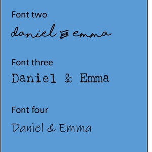 May include: Five different font styles of the names "Daniel & Emma" in black text on a light blue background.