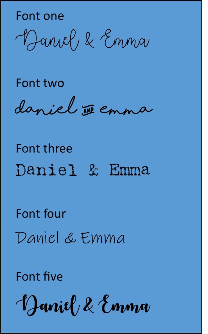 May include: Five different font styles of the names "Daniel & Emma" in black text on a light blue background.