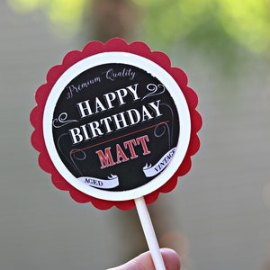 May include: Red and white round cake topper with black text that says "Premium Quality Happy Birthday Matt Aced Vintage".
