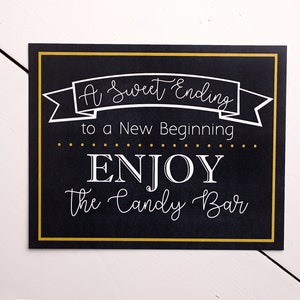 May include: A black chalkboard sign with a gold border and white text that reads "A Sweet Ending to a New Beginning... ENJOY the Candy Bar".