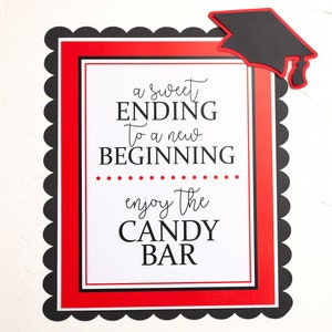 May include: A red and black graduation party sign with a scalloped border. The sign says "a sweet ending to a new beginning... enjoy the candy bar". A black graduation cap is on the top right corner of the sign.
