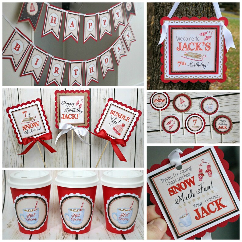 May include: A collection of winter-themed party decorations including a Happy Birthday banner, square signs with scalloped red borders, circular cupcake toppers on sticks, and red paper cups with Hot Cocoa labels featuring red and white text.
