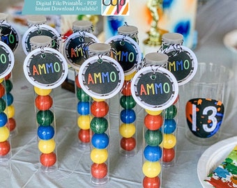 May include: A set of clear plastic tubes filled with colorful gumballs and topped with round, black and white printable tags that say "AMMO".