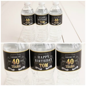 May include: Three black and gold water bottle labels with the text "Cheers to 40 Years!" and "Happy Birthday Tom".