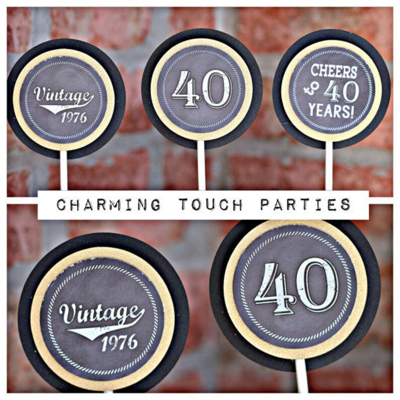 May include: Four black and gold round cake toppers with different designs. One topper says "Vintage 1976", another says "Cheers to 40 Years!" and the other two toppers have the number "40" on them.