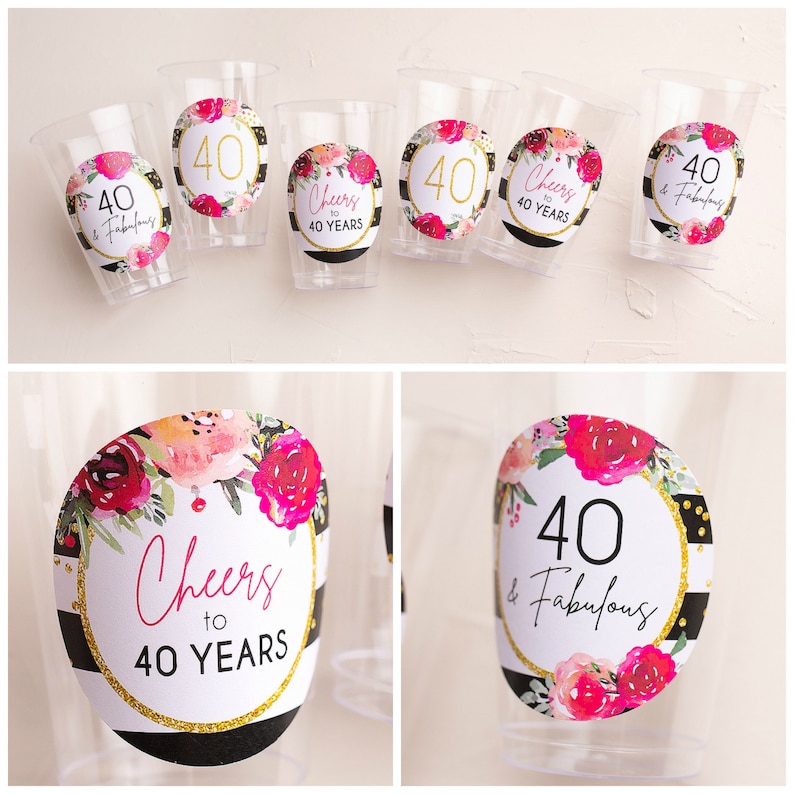 May include: Clear plastic cups with decorative stickers. The stickers feature floral designs, the number "40", and phrases like "Cheers to 40 Years" and "40 & Fabulous" in black and gold. The cups are for a birthday celebration.