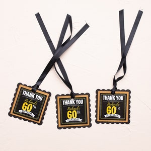 May include: Three black and gold thank you tags with scalloped edges. The tags say "Thank You for celebrating Richard's 60th Birthday".
