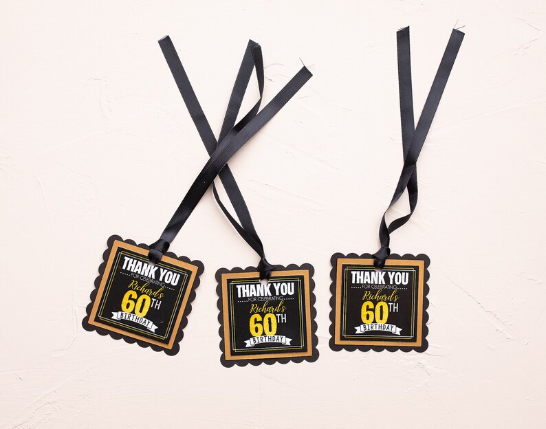 May include: Three black and gold thank you tags with scalloped edges. The tags say "Thank You for celebrating Richard's 60th Birthday".