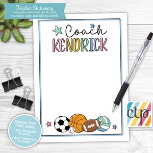 May include: A printable notepad template with a sports theme. The notepad features a colorful title "Coach Kendrick" with stars and a border. The bottom of the notepad features a row of sports balls including a soccer ball, basketball, football, baseball, and volleyball. The text "Choose from TWO sizes: 5x7 Notepads 50 sheets 8x10 Notepads 50 sheets" is in the bottom left corner.