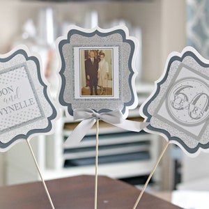 May include: Three silver glitter table centerpieces with a photo of a couple, the names Don and Wynnelie, and the text "60 Years".