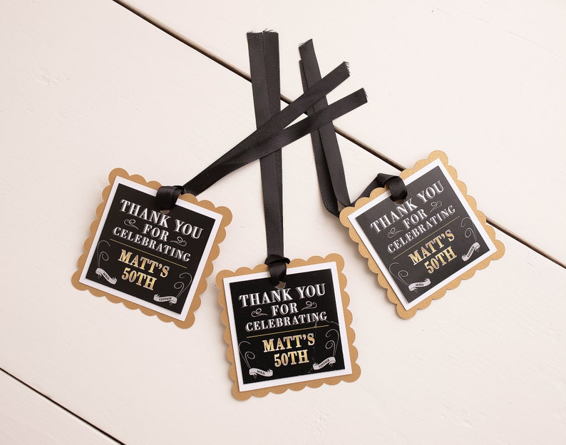 May include: Three black and gold favor tags with scalloped edges and black ribbon. The tags say "Thank you for celebrating Matt's 50th".