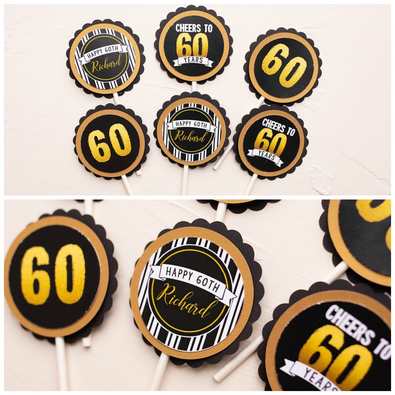 May include: A selection of cupcake toppers in black, gold, and white, designed for a 60th birthday. The toppers display the number "60" in gold, alongside phrases such as "Happy 60th Richard" and "Cheers to 60 Years."