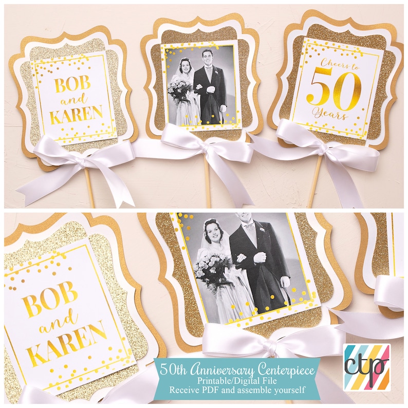 May include: Printable 50th anniversary centerpiece with gold glitter and confetti design. The centerpiece features a photo frame with a black and white photo of a couple, a sign that says "Cheers to 50 Years", and a sign that says "Bob and Karen".