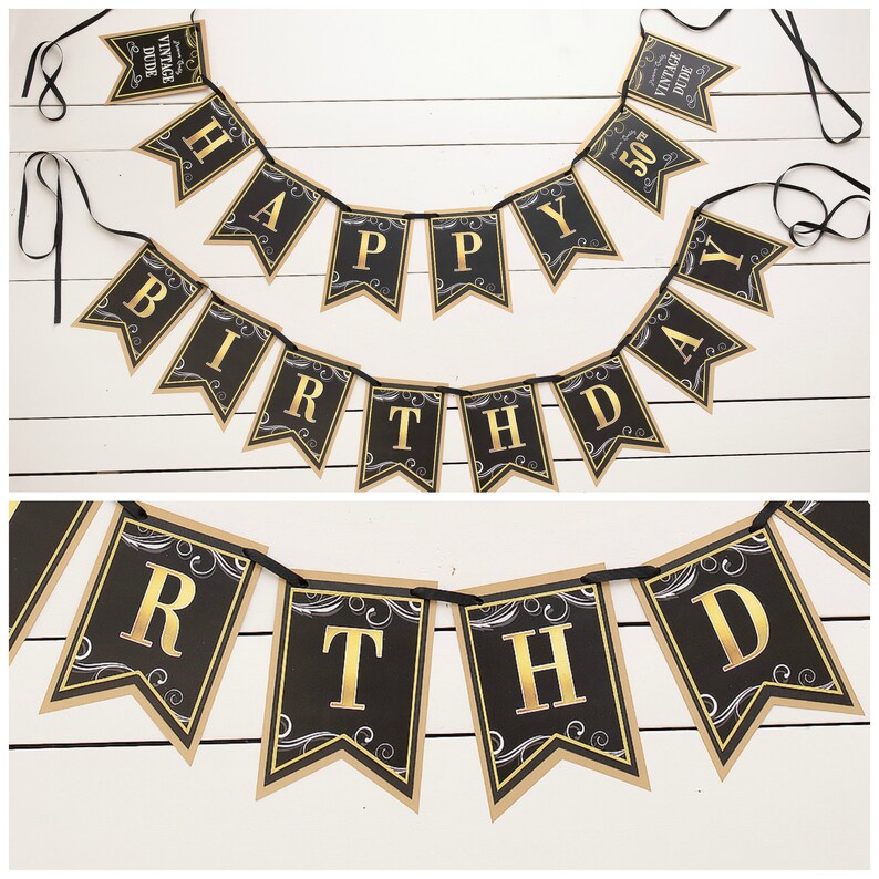May include: Black and gold happy birthday banner with a vintage dude design. The banner is made of paper and has a black background with gold lettering. The banner is strung together with black ribbon.