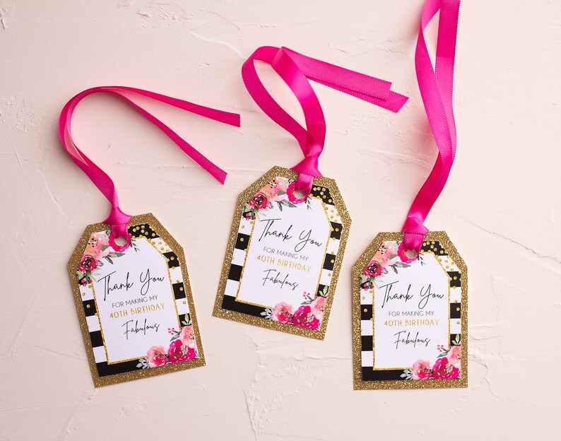 May include: Three gift tags with pink ribbons. Each tag has a gold glitter border, black and white stripes, and a floral design with pink and red flowers. The text reads "Thank You for making my 40th birthday fabulous."