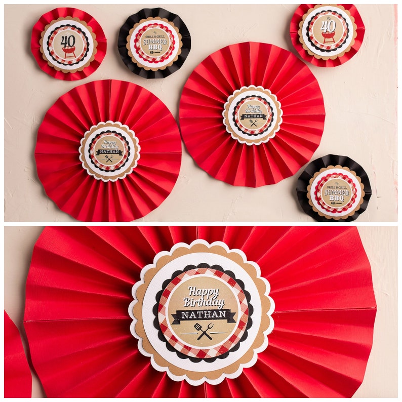 May include: Red and white paper fan decorations with a brown circle in the center. The circle has a black and white checkered pattern and the text "Happy Birthday Nathan".
