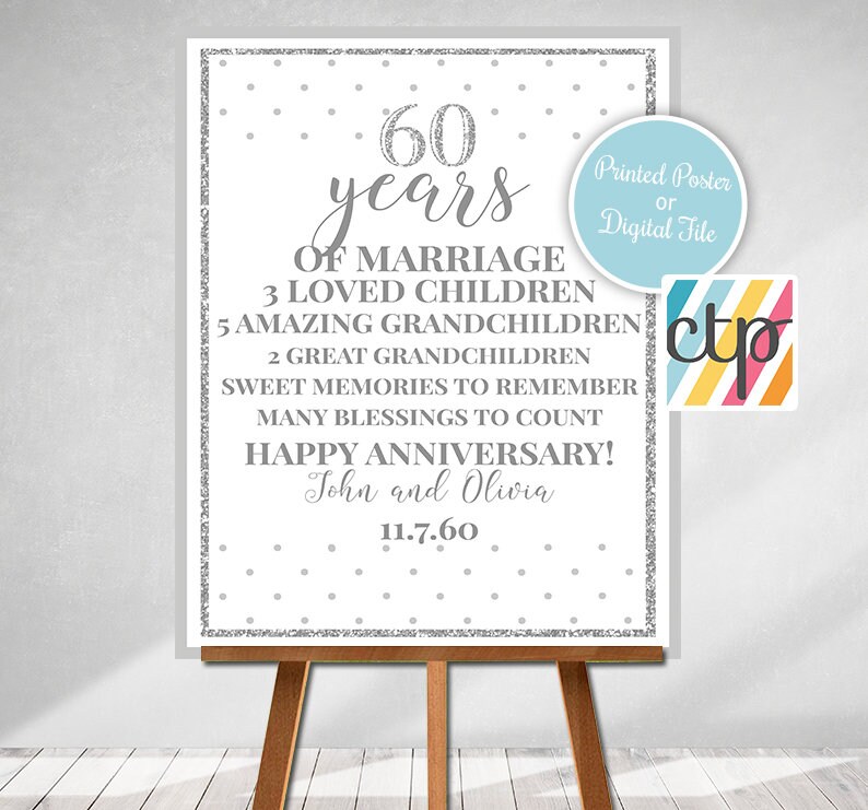 May include: A silver glitter-style poster with a white background and black text. The poster says "60 years of marriage, 3 loved children, 5 amazing grandchildren, 2 great grandchildren, sweet memories to remember, many blessings to count, Happy Anniversary! John and Olivia 11.7.60". The poster is on an easel.