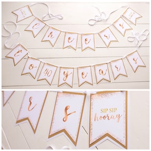 Puede incluir: Una pancarta dorada y blanca con las palabras "Cheers to 40 years" y "Sip Sip Hooray".