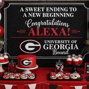 May include: A graduation party table with a red and black theme. The table features a cake, cupcakes, cookies, and a banner that says "Congratulations ALEXA!" and "University of Georgia Bound."