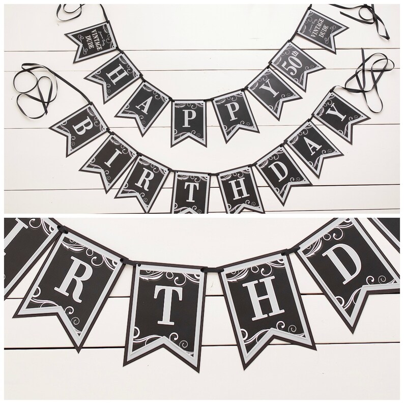 May include: Black and silver happy birthday banner with the words "Vintage Dude" and "50th" on two of the flags.