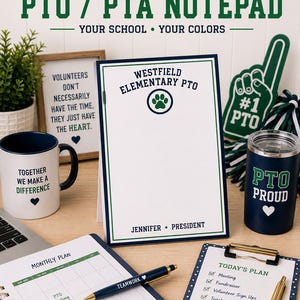 May include: A personalized notepad featuring the text Westfield Elementary PTO, a paw print icon, and the name Jennifer President. The notepad has a white background with a dark blue and green border, displayed alongside a mug, tumbler, and planner.